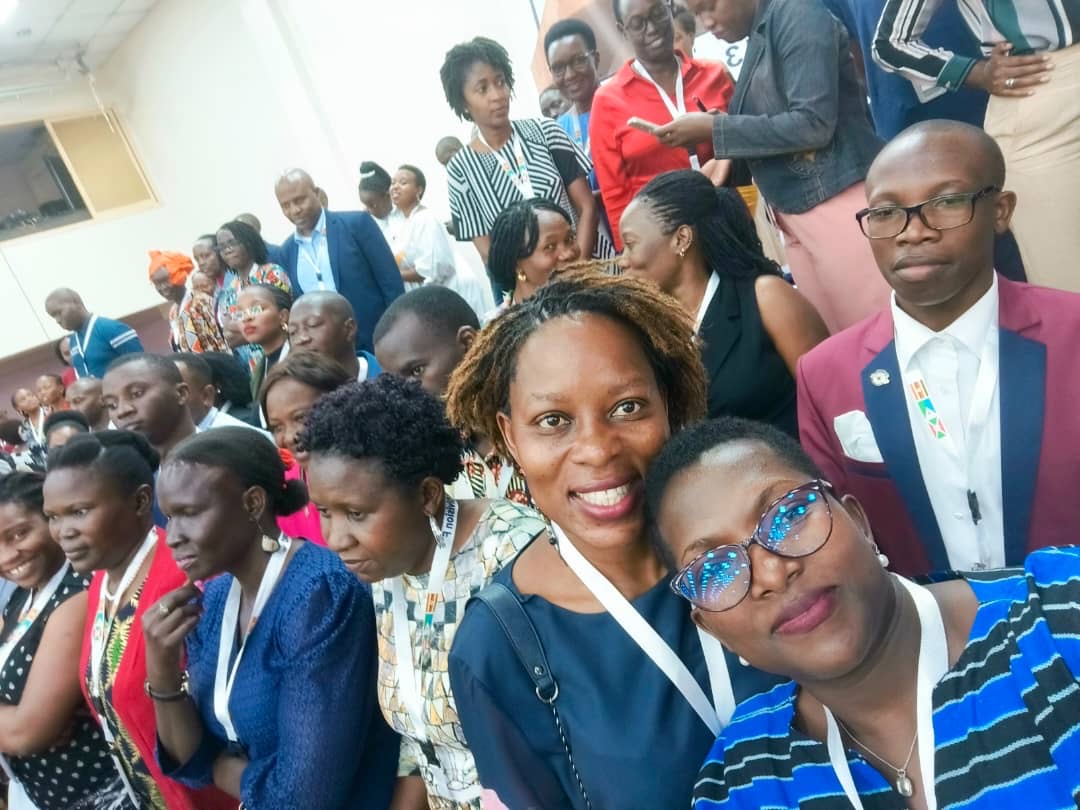 People at a concert facing the stage with various colours of paint powder in the air