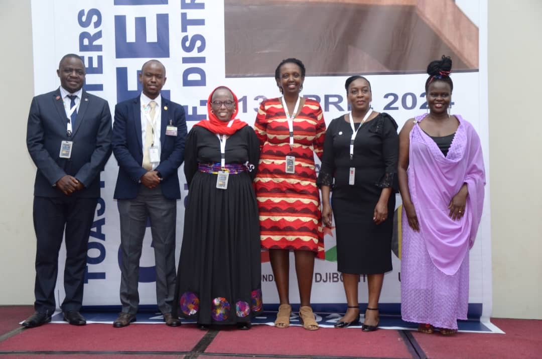 People at a concert facing the stage with various colours of paint powder in the air