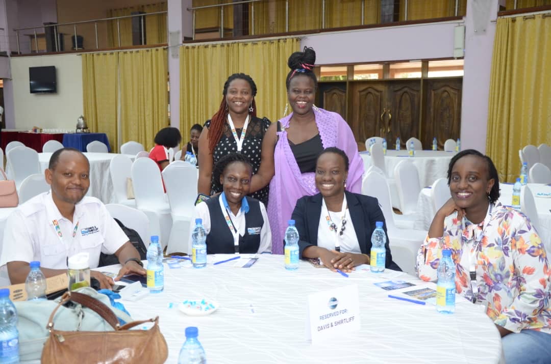People at a concert facing the stage with various colours of paint powder in the air